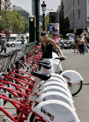 A girl takes a &quot;Bicing&quot; bike - part of a shared bicycle scheme - for a ride on July 18, 2007, in Barcelona
