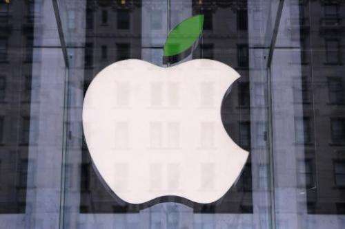 A green leaf adorns the Apple logo on Earth Day at the company's Fifth Avenue store in Midtown Manhattan on April 22, 2014 in Ne