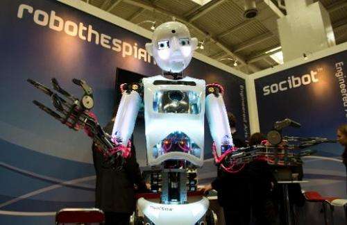 A lifesize humanoid robot &quot;RoboThespian&quot; interacts with fair visitors at the Engineered Arts Ltd stand of the 2014 CeB