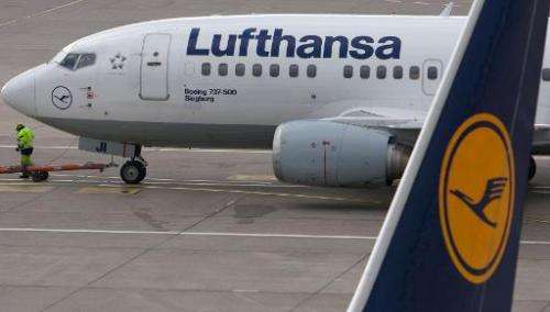 A Lufthansa plane is pulled across the runway at Berlin's airport Tegel on February 9, 2011