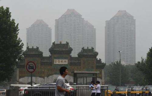 A man crosses a road on a polluted day in Beijing on July 3, 21014