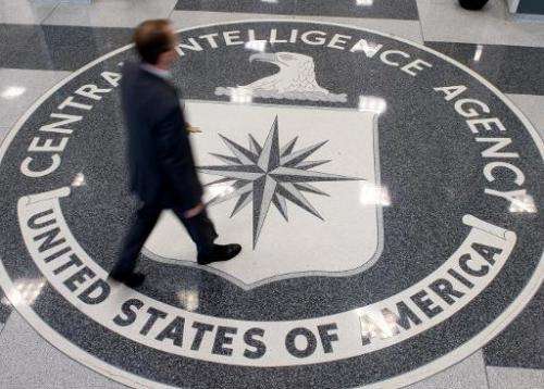A man crosses the Central Intelligence Agency (CIA) logo in the lobby of CIA Headquarters in Langley, Virginia, on August 14, 20