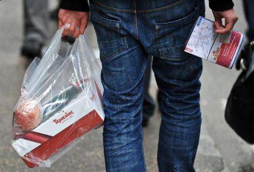 A man holds a plastic bag in Rome on December 31, 2010
