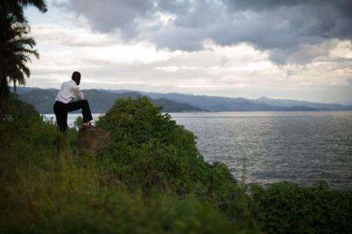 A man looks towards the hills of Rwanda on the eastern edge of Lake Kivu from the Democratic Republic of the Congo's eastern cit