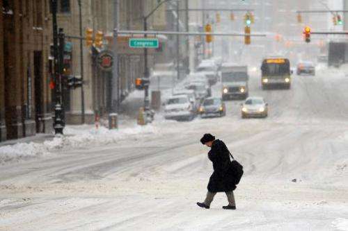 A man navigates the street as the area deals with record breaking freezing weather on January 6, 2014 in Detroit, Michigan