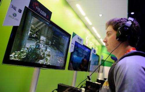 A man plays 'Gears of War 3' at Microsoft's Xbox 360 display at the 2012 International Consumer Electronics Show at the Las Vega