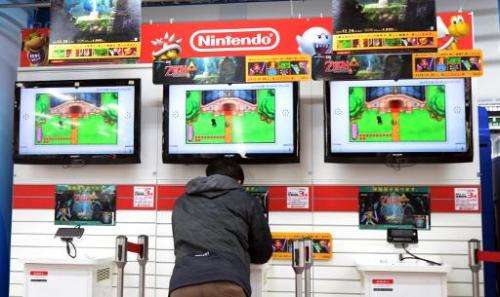 A man plays Nintendo's portable video game console at an electronic shop in Tokyo on January 17, 2014