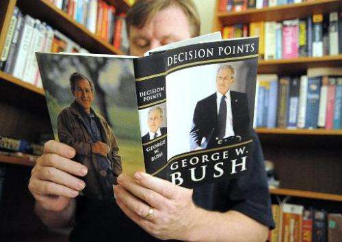 A man reads a memoir by former US President George W. Bush in this November 9, 2010 at his home in Manassas, Virginia