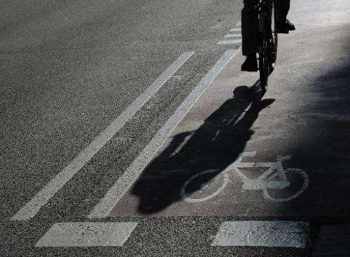 A man rides a bike lane in central Barcelona on February 20, 2013