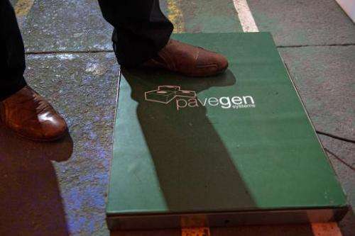 A man steps on a &quot;Pavegen&quot; panel, invented by British Laurence Kemball-Cook, during the inauguration of a new football