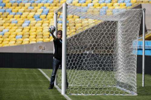 A man tests the goalline technology to be used at the World Cup is pictured at Maracana Stadium in Rio de Janeiro on June 9, 201