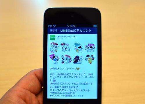 A man uses a smartphone-based social networking service (SNS) &quot;LINE&quot; in Tokyo on August 3, 2014
