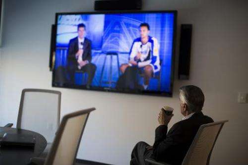 A man watches a live television broadcast October 17, 2013 in San Francisco, California