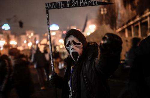 A man with a mask at Independence Square in Kiev on February 24, 2014