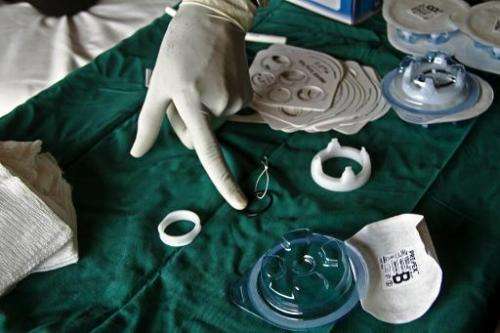 A medical staff member points at a non-surgical circumcision device called Prepex in Mukono on May 12, 2014