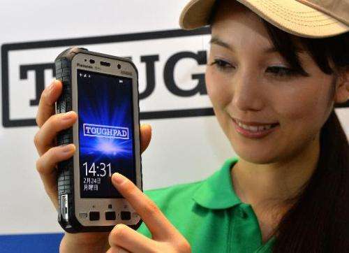 A model displays a new Panasonic &quot;Toughpad FZ-X1&quot; heavy duty tablet in Tokyo on February 24, 2014