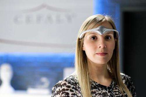A model wears the classic model of Cefaly Technology's new head band device to be used against migraines at Cefaly Technology in