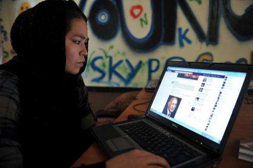 An Afghan ethnic Hazara woman browses the Facebook website at the Young Women For Change internet cafe in Kabul on July 22, 2012