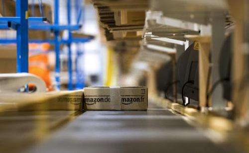 An Amazon parcel is seen on a conveyor belt before being shipped to a client on December 13, 2012