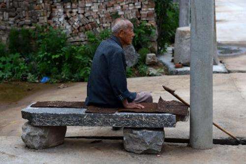 An elderly man rests on a seat in Weijian village, in China's Henan province on July 30, 2014