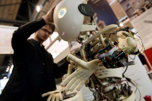 An engineer looks over Roboy, a humanoid robot developed at the Artificial Intelligence Laboratory of the University of Zurich, 