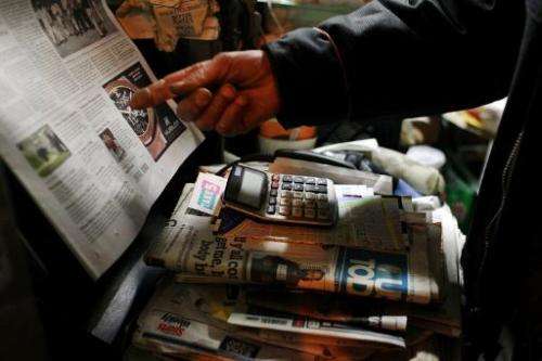 A newspaper vendor in Manhattan's Cooper Square prepares to close up his kiosk on April 4, 2012 in New York City