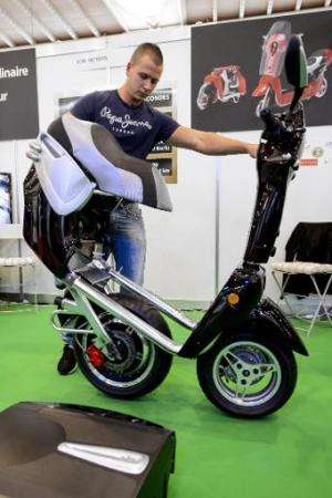 An exhibitor presents an electric folding scooter, created by French inventor Fabrice Marion, during the opening day of the Inte