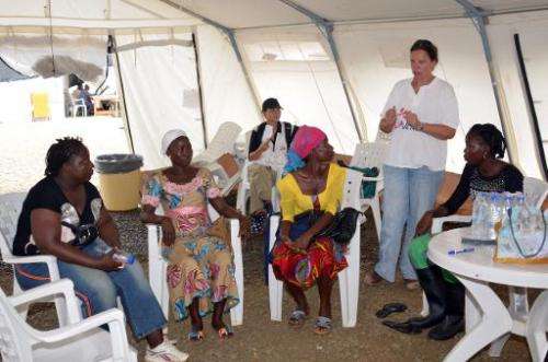 A nurse speaks to women who survived the Ebola virus during a training to become advisers for patients suffering from the diseas