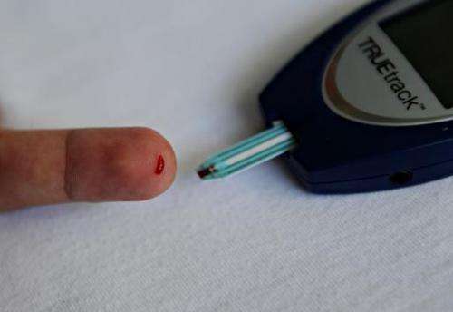 A patient with diabetes monitors his blood glucose at a public hospital in Managua, on September 22, 2011