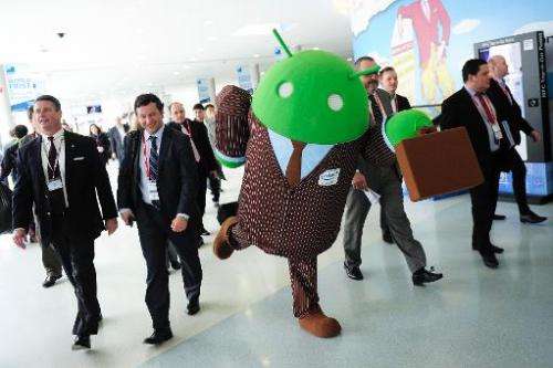 A person dressed up as an Android operating system character greets visitors at the 2014 Mobile World Congress in Barcelona on F