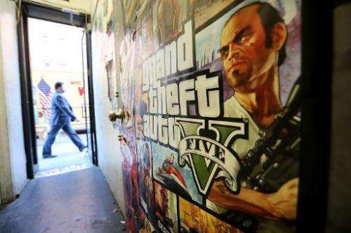 A poster promoting Grand Theft Auto V is attached to a wall at a video games shop on September 18, 2013 in New York City