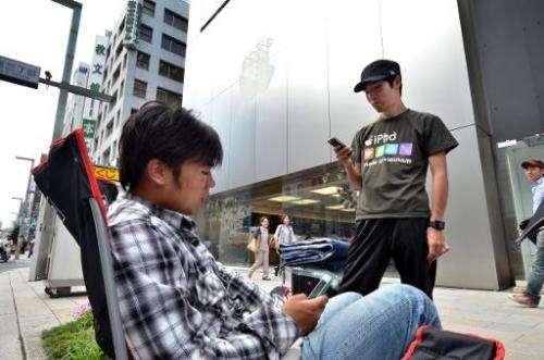 Apple gadget fans queue outside of an Apple store for the iPhone 6's release in Tokyo, on September 10, 2014