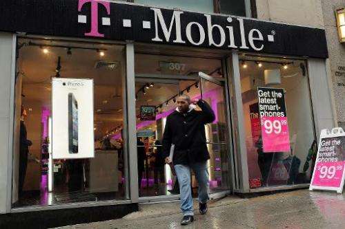 Apple's iPhone 5 is advertised in the window of a Manhattan T-Mobile store on April 12, 2013 in New York City