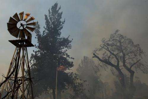 A ranch is left a smoldering ruin by the Cocos fire, in San Marcos, California, on May 15, 2014