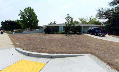 A resident's brown lawn can be seen in the city of Glendora, east of Los Angeles on July 29, 2014 in California, where a neighbo