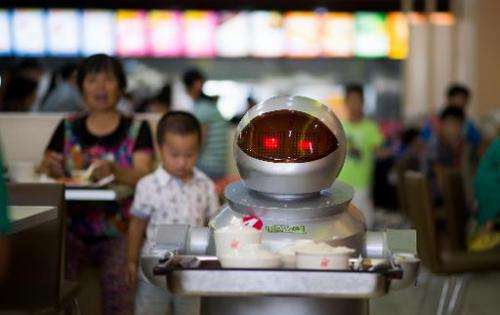 A robot carries food to customers in a restaurant in Kunshan, China on August 13, 2014