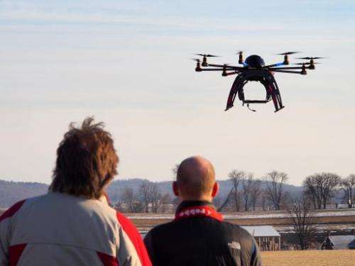 A small remote-controlled drone hovers in the sky at a meet-up of the DC Area Drone User Group on February 1, 2014