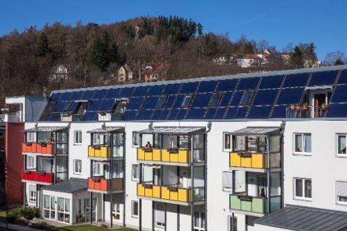 A solar thermal energy system is seen on the roof of a residential complex in Ilmenau, central Germany, on February 24, 2014