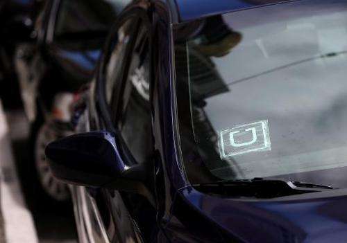 A sticker with the Uber logo is displayed in the window of a car on June 12, 2014 in San Francisco