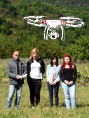 A teacher flies a drone as part of a class on aerial photography to high school students  on May 15, 2014 in France