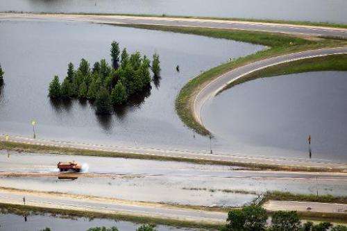 A truck drives along a flooded highway on the Mississippi River on May 23, 2011 in Vicksburg, Mississippi