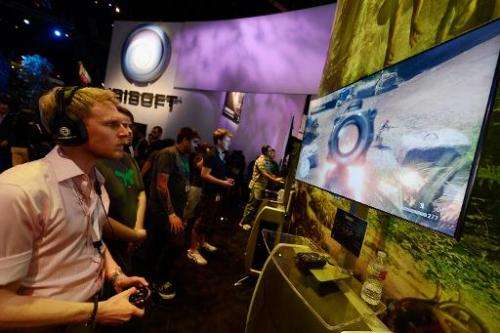 Attendees play the video game &quot;Far Cry&quot; in the Ubisoft booth at the E3 gaming conference on June 5, 2012 in Los Angele
