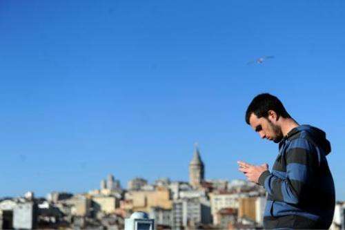 A Turkish man uses his smartphone, in the Eminonu district of Istanbul, on March 21, 2014