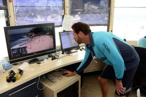 Australia's best known lifeguard Bruce 'Hoppo' Hopkins monitors different parts of beaches at Bondi Beach in Sydney on October 2