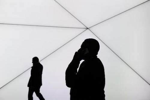A visitor speaks on his phone in Barcelona on February 25, 2014, on the second day of the 2013 Mobile World Congress