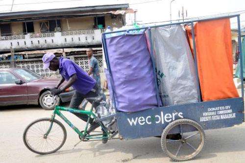 A 'Wecycler' pedals through the streets on his special bicycle, picking up bags of recyclable goods from the customers, who earn