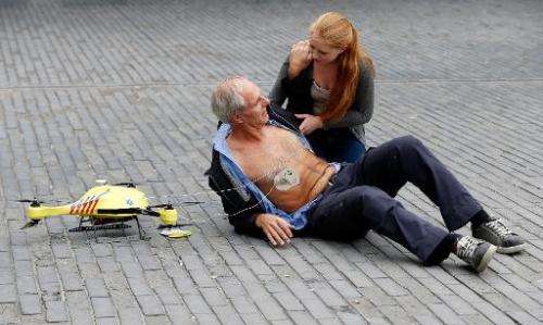 A woman gives a demonstration of an ambulance drone with a built in defibrillator at the campus of the Delft Technical Universit