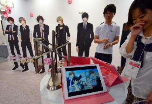 A woman play a romantic video game with virtual boyfriends at the annual Tokyo Game Show in Chiba, on September 18, 2014
