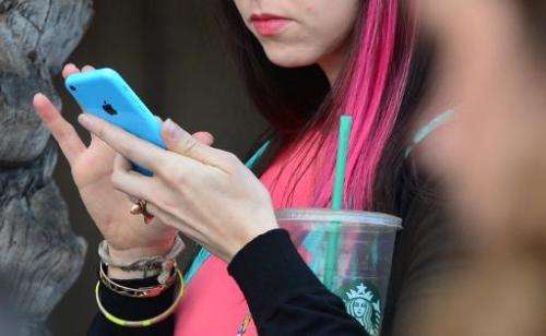A woman uses her cellphone on January 7, 2014 in Los Angeles, California