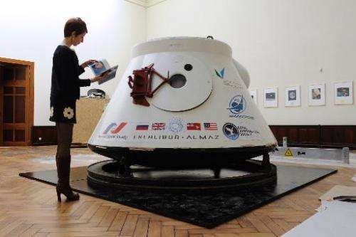 A women stands next to Soviet space capsule Vozvrashchayemi, on April 23, 2014, in Brussels, ahead of its auction on May 7, 2014